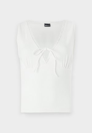 Balta be rankovių palaidinė su V formos iškirpte, papuošta nėriniu ir priekyje surišama. Pagaminta iš lygios medžiagos, su prigludusia siluetu.