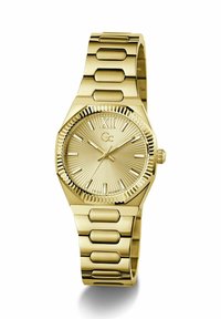 Montre-bracelet en ton or avec lunette cannelée, cadran soleillé, chiffre romain XII, index bâtons, et bracelet métallique à maillons.