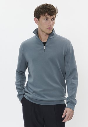 Gray zip-up sweatshirt with a high collar, smooth texture, and long sleeves. Features a subtle sheen and fitted design.