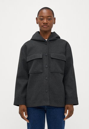 Dark gray hooded jacket made of textured fabric, featuring two chest pockets, black button closures, and a relaxed fit.