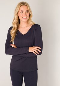 Marineblauwe langmouw T-shirt met V-hals in een zachte, gestructureerde stof met naadloze manchetten, gecombineerd met bijpassende fitted legging.