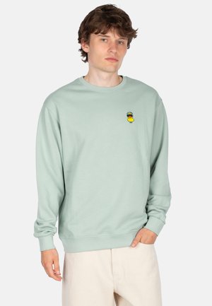 Light green sweatshirt with ribbed cuffs and hem, featuring a small embroidered yellow duck logo on the left chest area.
