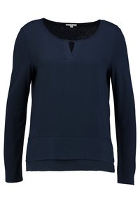 Blouse pour femme à manches longues bleu marine avec encolure ronde et fente à l'avant, ourlet à couches, taille small.