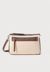 Beige canvas crossbody bag with brown leather accents, featuring two zippered compartments and a flat front pocket. Adjustable strap included.