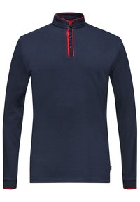 Marinblus med lång ärm och ställbar krage, med röd knapplist och strukturerade ärmar med röda detaljer vid manschetterna.