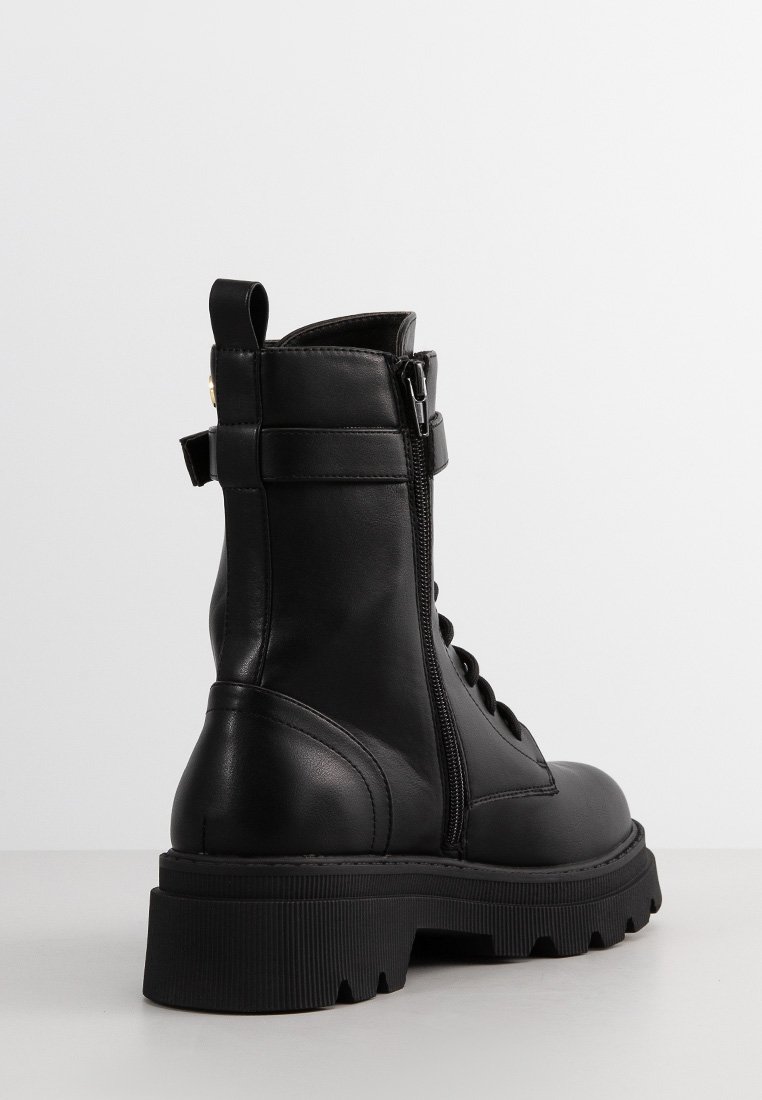 Stivaletti neri in pelle con allacciatura frontale, chiusura laterale con zip, suola in gomma spessa e un'impugnatura a loop sul retro.