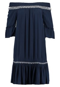 Robe bleu marine à épaules dénudées avec manches à volants, tissu texturé et accents brodés blancs au niveau de l'encolure et de l'ourlet. Bas évasé.