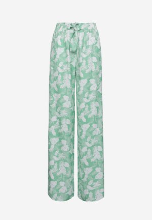 Pantalones verde claro de corte holgado, con una cintura elástica y patrones de hojas tropicales blancas en toda la tela.