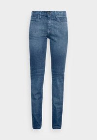 Jeans ajustados de denim en azul oscuro, con bolsillos frontales, un bolsillo para monedas y un cierre de botón único en la cintura.