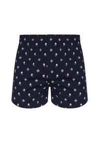 Granatowe bokserki z elastycznym pasem, pokryte powtarzającym się wzorem białych i czerwonych czapek Mikołaja oraz płatków śniegu.