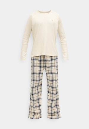 Cremefarvet langærmet top med ribbet tekstur og lille logo; ternede pyjamasbukser i creme, sort og beige farver. Design med afslappet pasform.