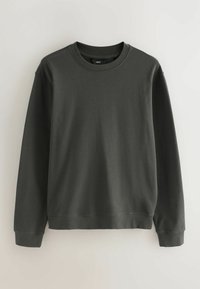 Donkergroen sweatshirt van een zachte katoenmix. Voorzien van een ronde hals, lange mouwen en ribgebreide boorden en onderkant voor een comfortabele pasvorm.