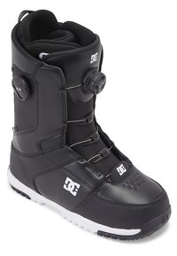Botte de snowboard noire avec un extérieur en cuir lisse, système de laçage BOA et semelle en caoutchouc blanche avec grip texturé. Logo DC sur le côté.