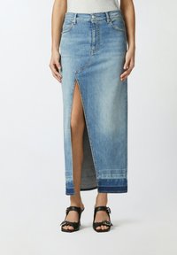 Svijetloplavi denim maxi suknja s prednjim prorezom, visokim strukom i kontrastnim donjim rubom. Ima klasično šivanje i prednje džepove.