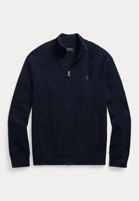 Marineblauwe sweater met rits, gemaakt van gestructureerde stof; heeft een opstaande kraag, twee zijzakken en een klein geborduurd logo op de borst.