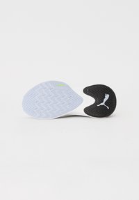 Shoe sole with a white rubber base featuring a zigzag tread pattern. Black rubber section with Puma logo provides contrast and grip.