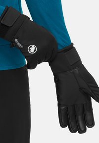 Black mittens with leather palms and fabric backs. Features adjustable wrist straps and logos. Worn over a blue long-sleeve shirt.