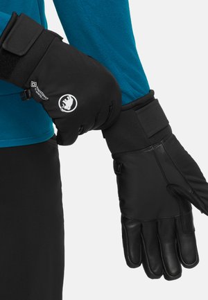 Black mittens with leather palms and fabric backs. Features adjustable wrist straps and logos. Worn over a blue long-sleeve shirt.