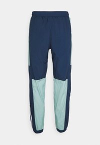 Námořnické modré a světle zelené tepláky s elastickým pasem, se střihem v barvách, vyrobené z lehké texturované látky.