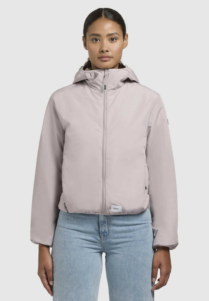 Light pink puffer jacket with a zip front, adjustable hood, and elastic cuffs, featuring a logo patch near the hem and side pockets.