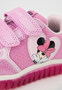 Pink children's sneakers with mesh fabric, dual Velcro straps, heart-shaped Minnie Mouse graphic, and a textured rubber sole.