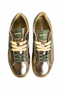 Sneaker in pelle bronzo con lacci verdi e gialli, dotate di un pannello accentato verde e una soletta interna texturizzata. Logo Diadora Heritage sulla linguetta.