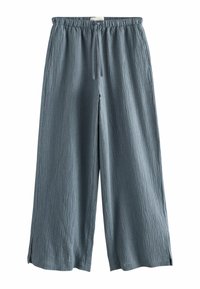 Pantalon ample bleu en tissu texturé avec taille élastique et cordon, avec fentes latérales à l'ourlet.