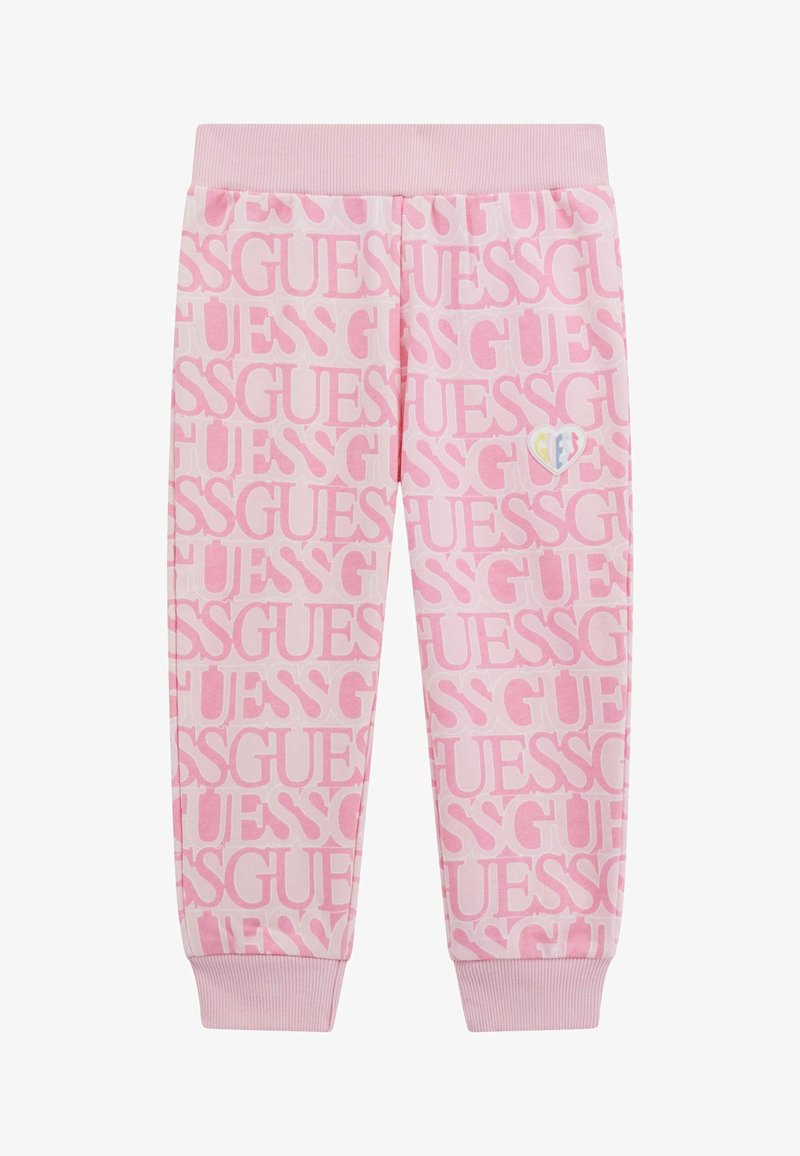 Różowe dresy z powtarzającym się wzorem logo "GUESS", prążkowanym pasem w talii i mankietami. Małe, kolorowe logo serca na boku.