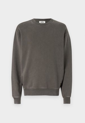 Gray sweatshirt made from soft fabric, featuring a crew neckline, long sleeves, ribbed cuffs, and a small logo tag on the lower side.