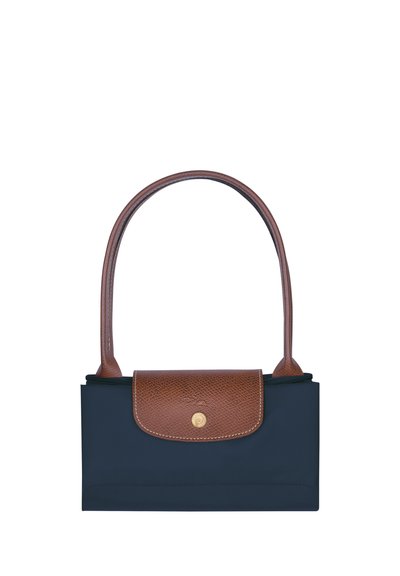 Navy blue nylon bag with a brown leather flap, featuring a gold snap closure and a single curved handle. Compact and rectangular shape.