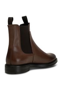 Brown leather Chelsea boot with elastic side panels, rounded toe, and a black textured rubber sole. Features a pull tab at the rear.