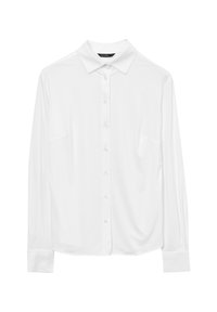 Camicia bianca a maniche lunghe con colletto a punta e polsini, esposta su uno sfondo bianco semplice.