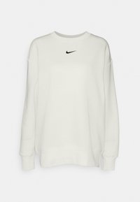 Sudadera blanca de Nike con cuello redondo, mangas largas y un logo negro en el pecho. La tela parece suave y texturizada.