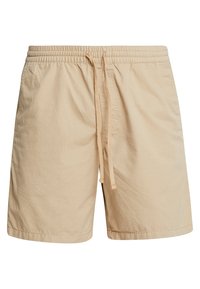 Shorts beiges en tissu léger, dotés d'une taille élastique avec cordon de serrage. Le design est simple, sans poches ni motifs.