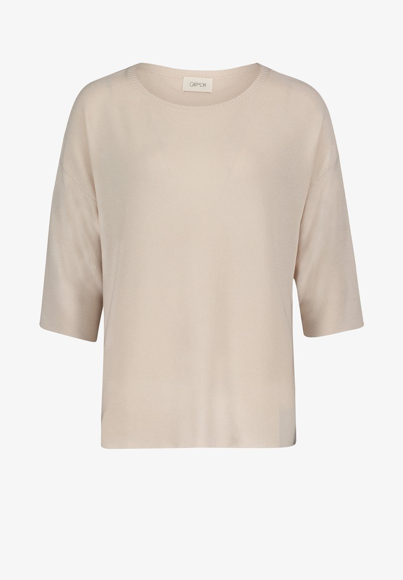 Beżowy, krótkorękawowy sweter dzianinowy z okrągłym dekoltem, luźny krój i fakturowany wzór. Miękka tkanina zwiększa komfort i oddychalność.