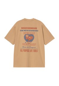 Camiseta oversized beige con gráficos impresos en la parte posterior, que presenta texto azul y rojo y un contorno en forma de corazón de Detroit. Tejido de algodón suave.