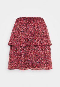 Jupe rouge à plusieurs couches avec un motif ludique de taches roses, bleues et noires. Taille élastique, tissu léger et ourlet à volants.