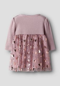 Robe rose pâle avec des manches longues côtelées, un buste et une jupe en tulle ornée de nœuds rose doré métallisé et d'accents circulaires.