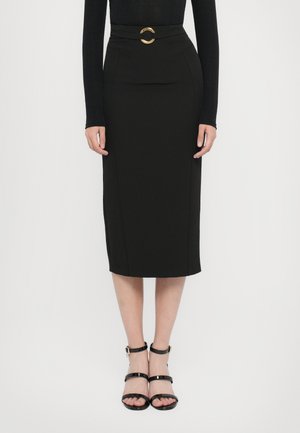 Black pencil skirt with a fitted design, high waist, and a gold circular belt accent. Worn with black strappy sandals. Smooth texture.