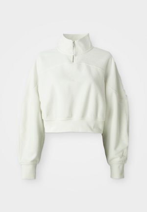 Gekürzter, hellbeiger Sweatshirt mit hohem Kragen und halbseitigem Reißverschluss. Verfügt über einen weichen, strukturierten Stoff und leicht oversized Ärmel.