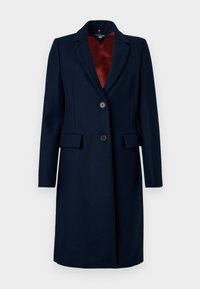 Marineblauer Wollmischmantel mit taillierter Passform, Reverskragen, einreihiger Knopfleiste und zwei siden Taschen. Futter in Burgunderrot.