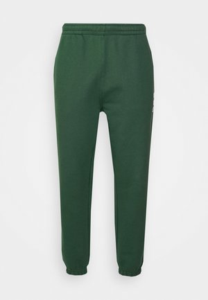 Joggers de cintura elástica en color verde oscuro con puños elásticos y bolsillos laterales, diseñados para uso casual.