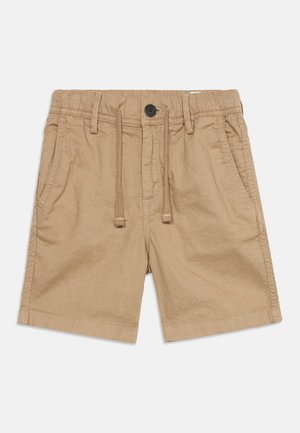 Beige bomullsshorts med elastisk midje, snor, frontknapp og to sidelommer, lagt flatt på hvit bakgrunn.