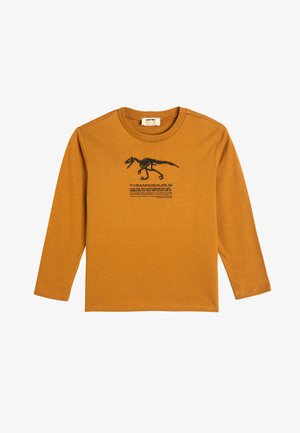 Langärmliges T-Shirt aus Baumwolle in Senfgelb mit einem schwarzen Dinosaurier-Graphic und dem zum Text "Tyrannosaurus". Mit rundem Halsausschnitt.