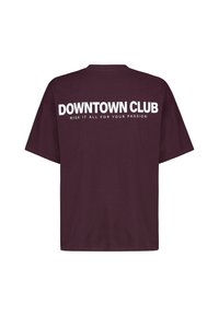 Maroon oversized T-shirt with white text "DOWNTOWN CLUB" and smaller text "RISK IT ALL FOR YOUR PASSION" on the back.