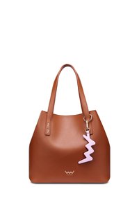 Brown leather tote bag with dual handles, featuring a pink lightning bolt charm attached. Smooth texture, minimalist design, and no visible hardware.