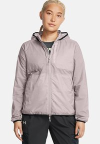 Light purple lightweight jacket with a hood, zippered front, and two pockets. Features elastic cuffs and a straight hem.