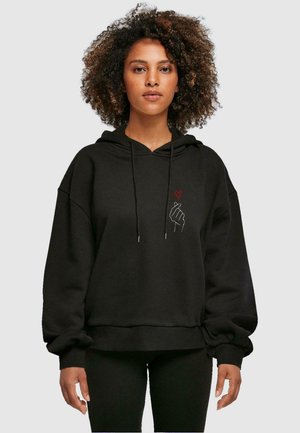 Black hoodie featuring a kangaroo pocket, drawstrings, and a graphic of a hand and heart in white and red. Soft, textured fabric.