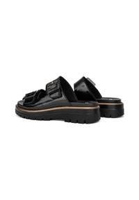 Black patent leather slide sandals with two buckle straps, thick black sole, and a light wood trim along the base. Textured finish on straps.