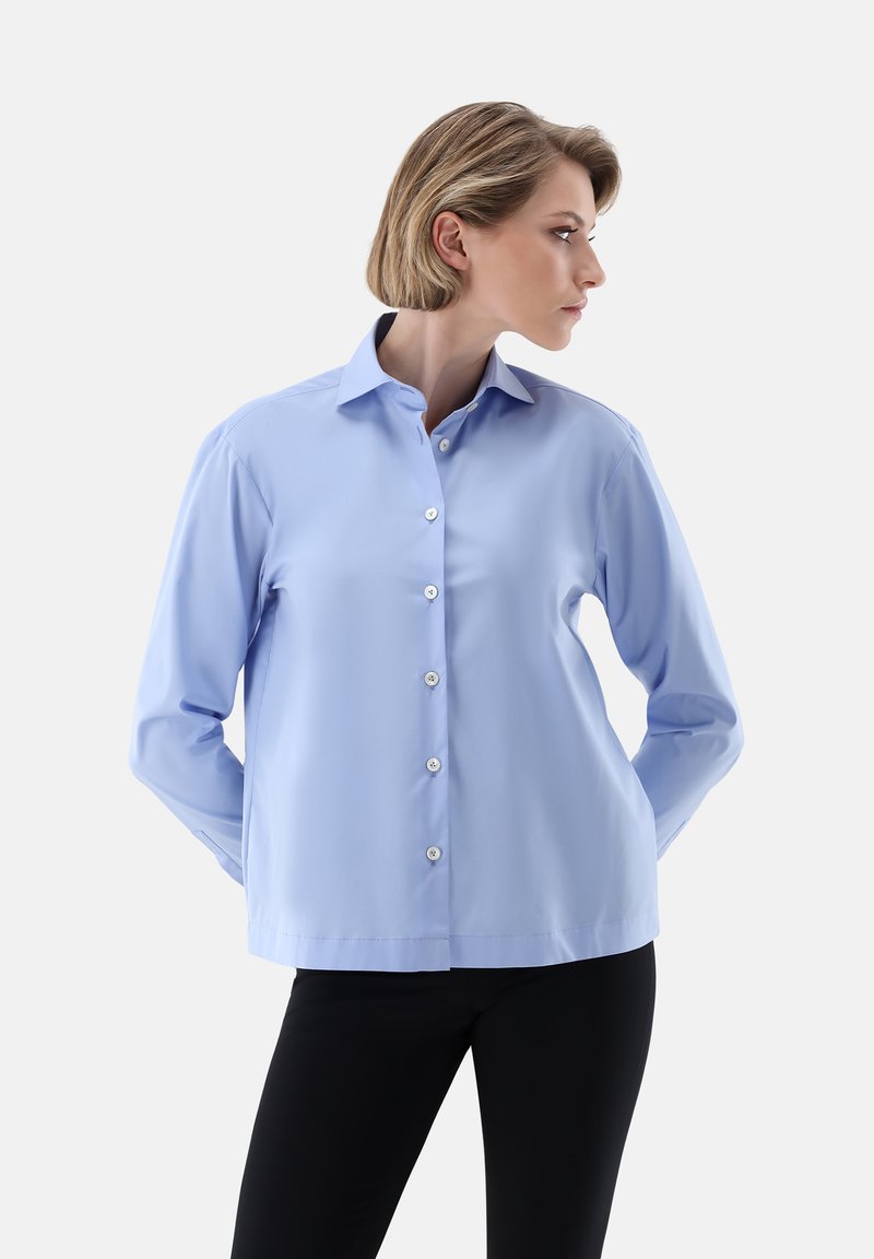 Light blue button-up shirt with long sleeves, a pointed collar, and white buttons, featuring a smooth texture and a relaxed fit.